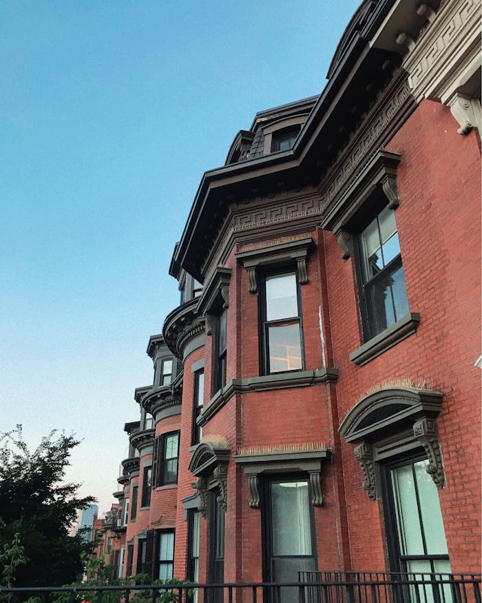 Home Low-angle view of historic brownstone in Boston, showcasing classic architecture and evening light.